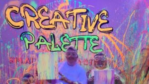 Family holding paintings in the neon splatter room at Creative Palette in Warsaw, MO
