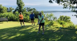 Three women golfing at Shawnee Bend Golf Course with Truman Lake in the background.