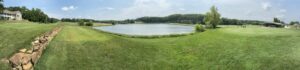 Triple Creek Golf Course in Cole Camp, MO with pond, clubhouse, and practice green.