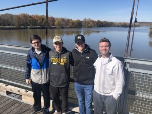 Group travelers walking across the Joe Dice Swinging Bridge in Benton County, Missouri