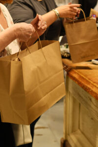Customers carrying shopping bags at a local store in Benton County, Missouri