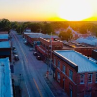 Benton County, Missouri has a lot of things to do for tourists. An aerial view of a small downtown Main Street at sunrise.