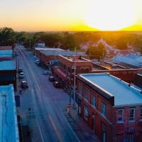 Benton County, Missouri has a lot of things to do for tourists. An aerial view of a small downtown Main Street at sunrise.