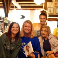 Smiles, shopping bags, and small-town charm—Benton County is full of fun finds and friendly faces in every boutique. Group of smiling women shopping at a boutique in Benton County, Missouri, holding gifts and enjoying a small-town shopping day trip.