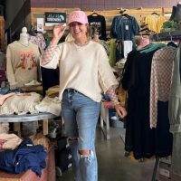 Find your style and support small-town shops during the 5th Annual Benton County Boutique Crawl — November 14–15, 2025. Shopper smiling inside a Benton County boutique during the annual Boutique Crawl, surrounded by cozy fall fashion and local charm.